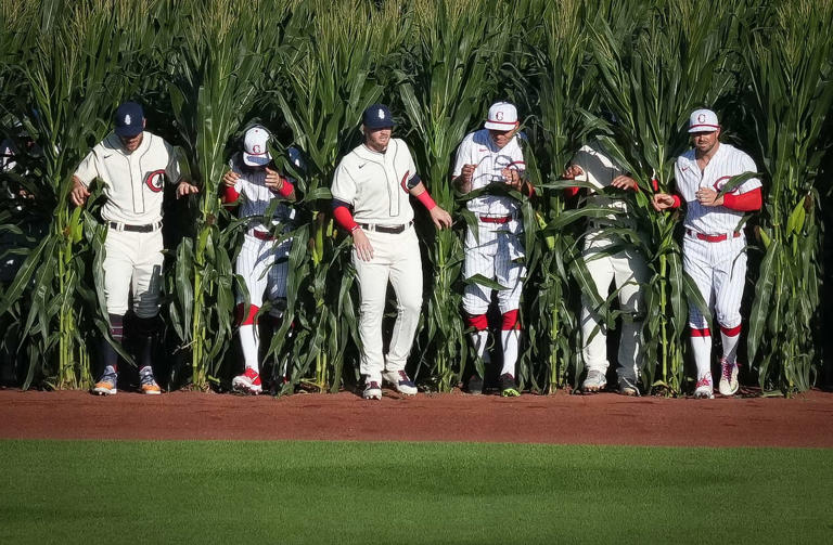 Members of the Chicago Cubs and Cincinnati Reds step out of the corn and onto the field prior to the start of a Major League Baseball game at the Field of Dreams in Dyersville in 2022.