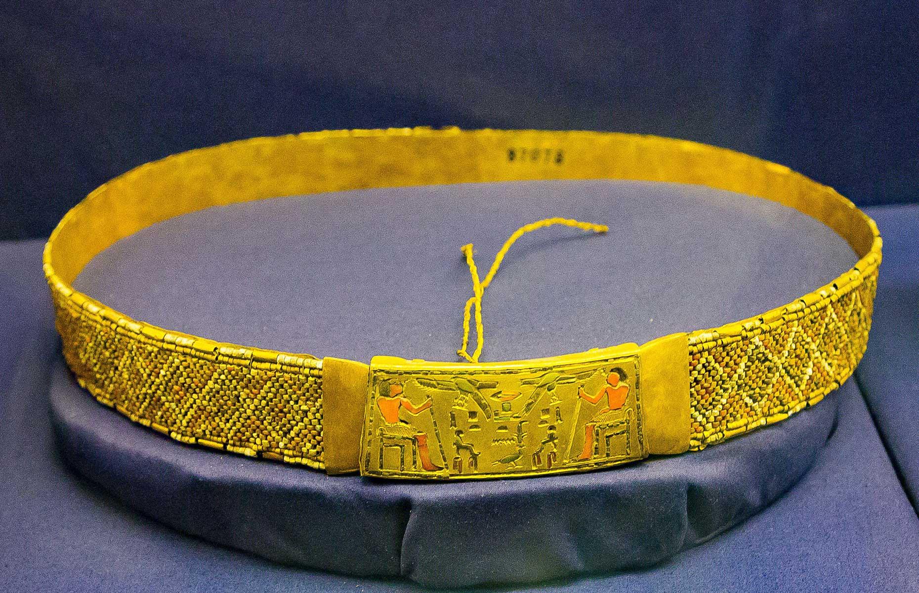 <p>Also found at the Saqqara site was this thin gold band measuring 90cm, placed among the mummy bandages of Prince Ptah-Shepses. Dating back to 2323-2150 BC, red carnelian (gemstone) and volcanic glass beads form angular, geometric patterns, while hieroglyphics are inscribed on the buckle.</p>