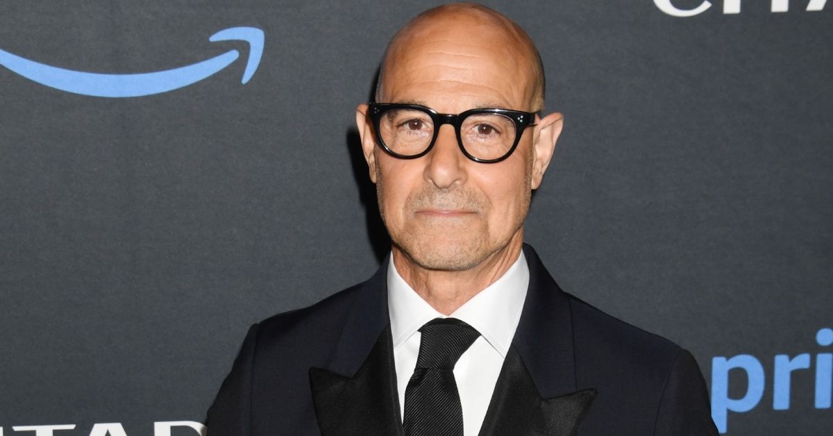 Stanley Tucci wearing a suit on a red carpet
