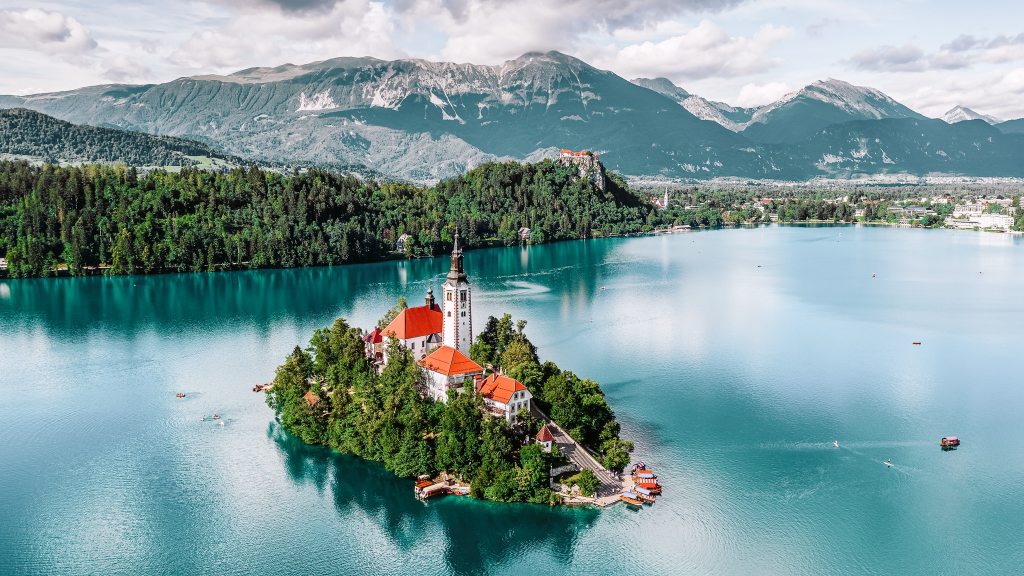 <p>A spectacular setting on the shores of glacial Lake Bled, and an 11th-century castle are among the attractions of Bled in Slovenia. The fortress dominates the townscape and overlooks the lake island church. Go now for superlative views, relaxing boat rides, and an incredibly romantic setting.</p><ul> <li>Read also: <a href="https://worldwildschooling.com/iconic-places-around-the-world/">Iconic Places Around the World</a></li> </ul>