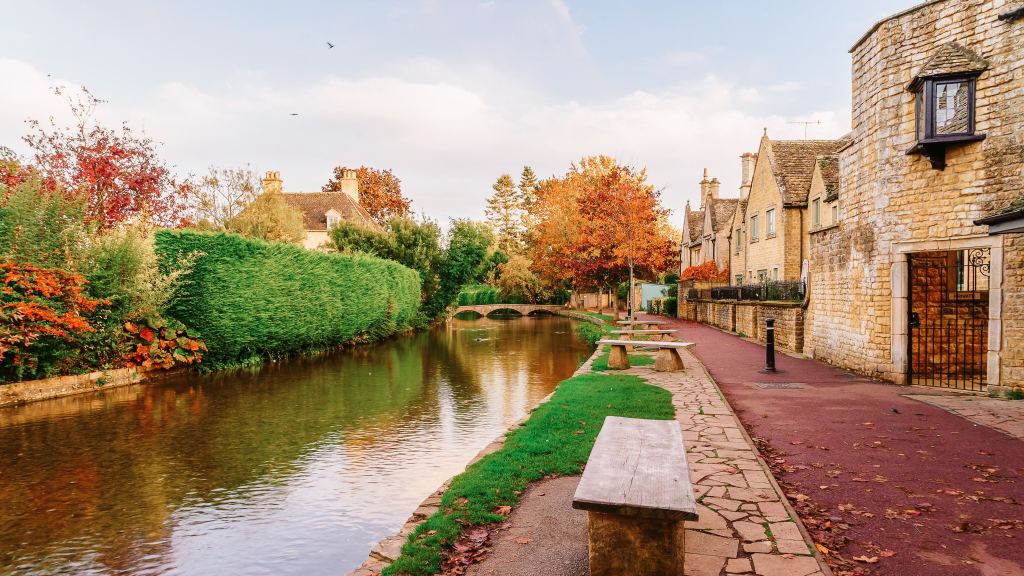 <p>Bourton-on-the-Water is in the Cotswolds, a designated English Area of Outstanding Natural Beauty. Expect old, honey-toned stone buildings alongside the River Windrush spanned with small bridges. It’s a lovely place to explore for the day or to make your Cotswolds base when staying a little longer.</p><ul> <li>Read also: <a href="https://worldwildschooling.com/5-captivating-uk-cities/">5 Captivating UK Cities</a></li> </ul>