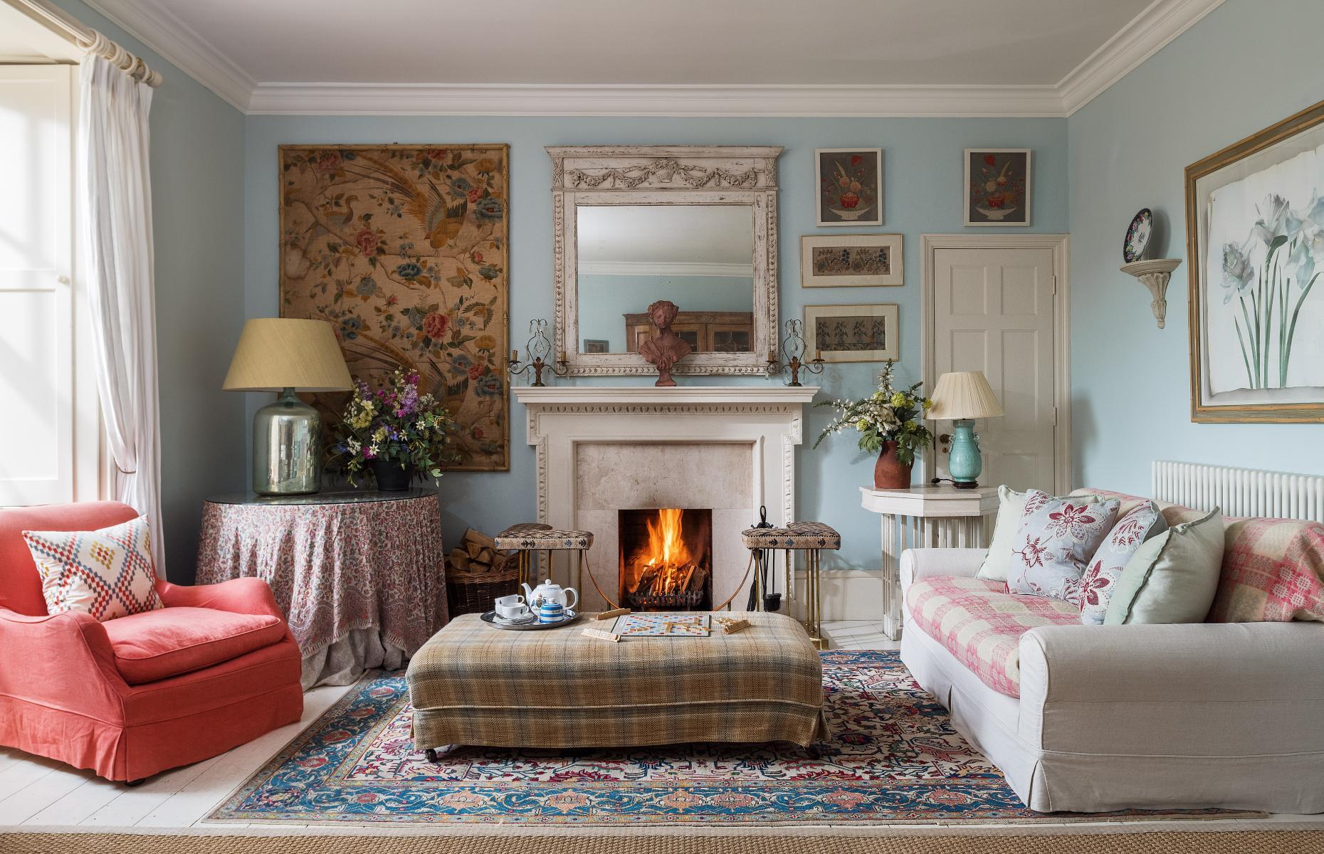 <p>They were no doubt impressed by its luxurious interiors designed by the Queen’s sister Annabel Elliot, who has taken great care to retain the character of the house while combining contemporary British brands with antique and market finds to create its inviting atmosphere.</p>  <p>The light blue walls set off a variety of textiles and artworks in this living room, while the antique rug was found at auction.</p>