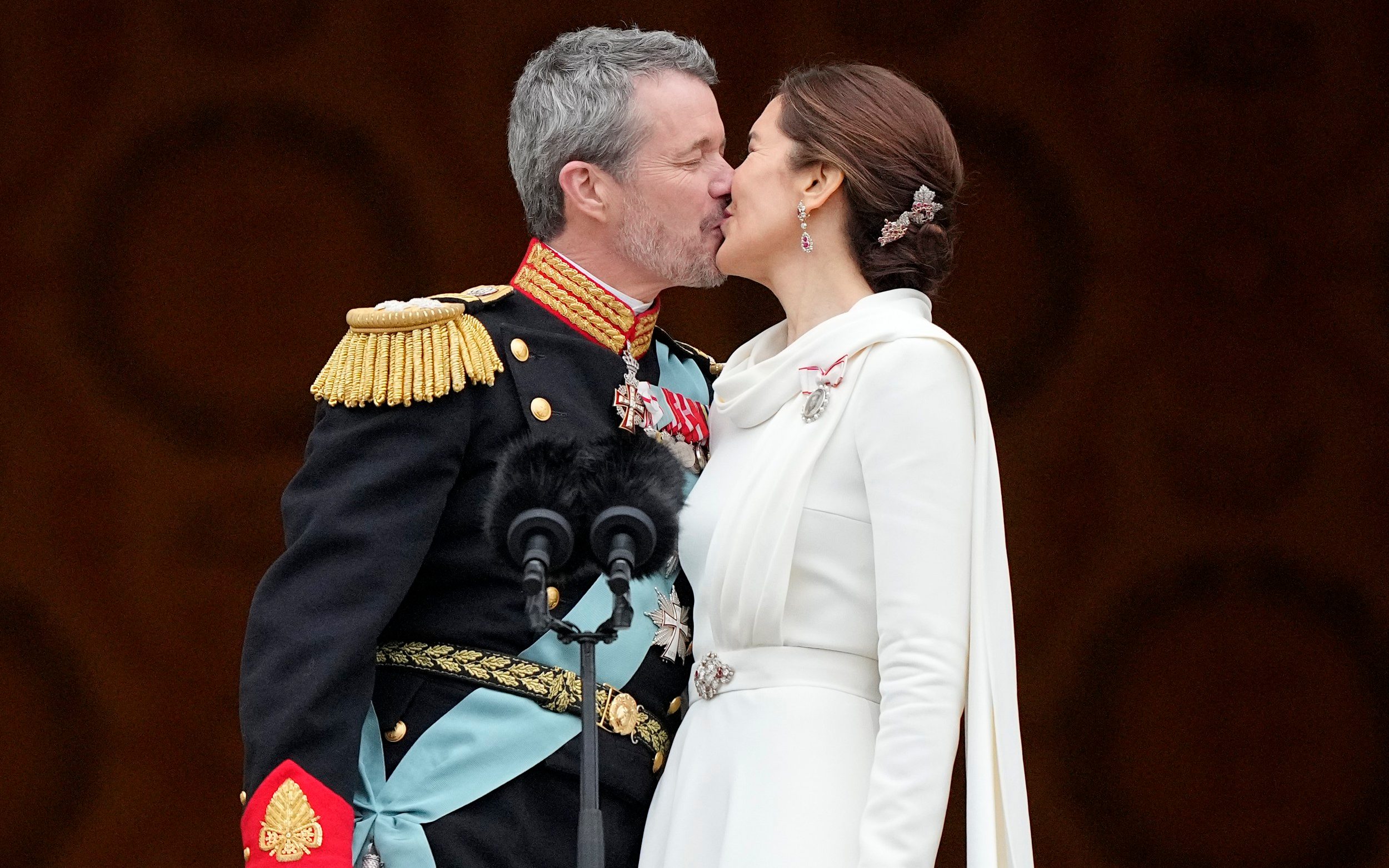 new danish king seals accession with awkward kiss on palace balcony
