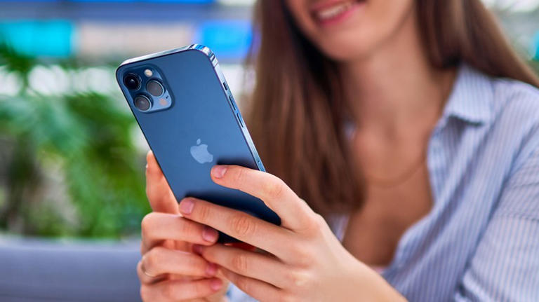 a woman using an iPhone 12