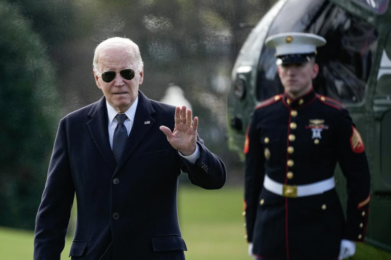 President Joe Biden waves as he departs Marine One as he returns to the White House December 19, 2023, in Washington, D.C. Biden warned in a statement Friday that the U.S. risks being pulled into a direct conflict with Russia if Moscow is successful in the Ukraine war.