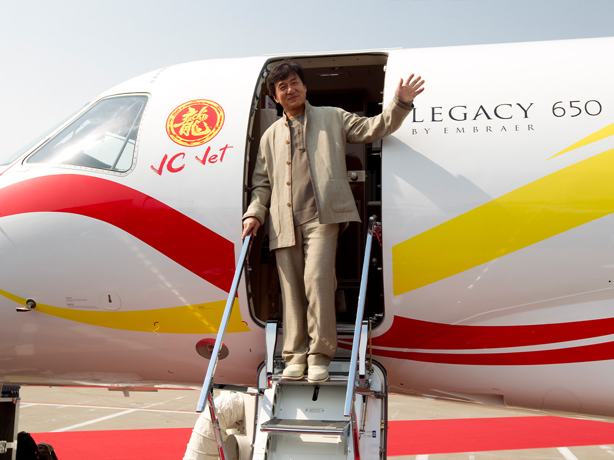 <p>Jackie Chan is one of the most iconic martial artists of all time, so it’s no wonder he’s got a private jet fit for a legend. Jackie Chan has been in Hollywood since the early ‘90s, so he’s had plenty of time to save up for the hefty price tag on his jet. We wonder if he had any idea at the beginning of his career that he’d have his own plane one day. </p> <p>Jacki Chan’s Embracer Legacy 650 is a giant plane. It’s so large that it is broken into three sectors. His jet comes with: </p>  <ul>  <li>An area for work and business</li>  <li>An area for a little rest and relaxation</li>  <li>An entertainment area</li>  <li>A painted dragon on the side</li> </ul>  <p>The plane also comes with its own Wi-Fi on board, so you could practically live on this plane if you wanted to! That’s what $30 million will buy you. </p>