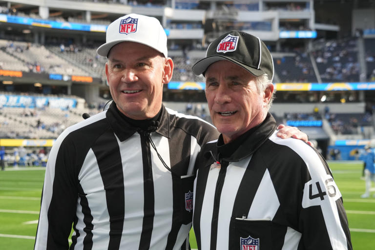 referee Clete Blakeman (34) and field judge Terry Brown (43) pose during the game between the Los Angeles Chargers and the Los Angeles Rams at SoFi Stadium.