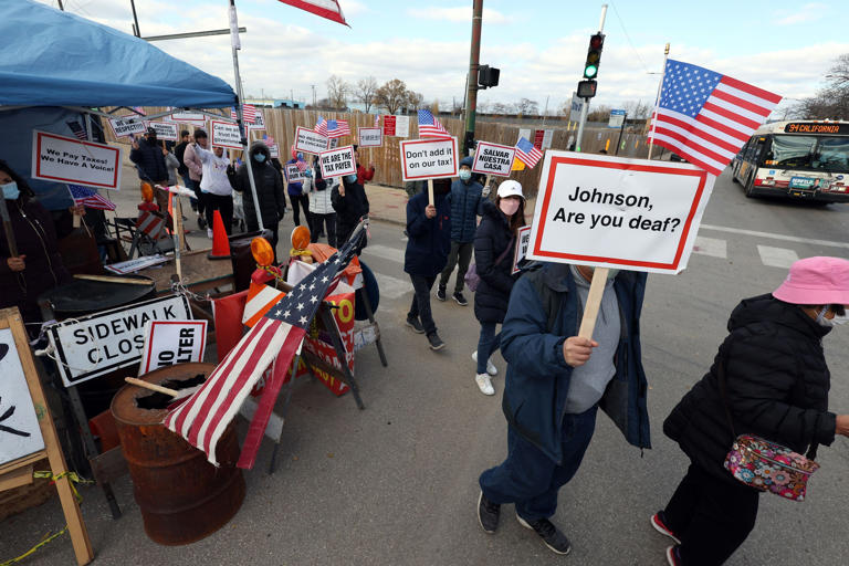 People protesting against the possible construction of a winterized tent camp for migrants on a vacant lot at 38th Street and California Avenue march to the Archer Avenue office of Ald. Julia Ramirez, 12th, on Nov. 10, 2023.