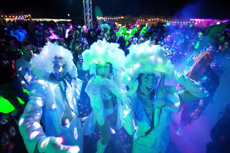 Attendees dance at the silent disco during Decadence Arizona at Phoenix Raceway in Avondale on Dec. 31, 2023.