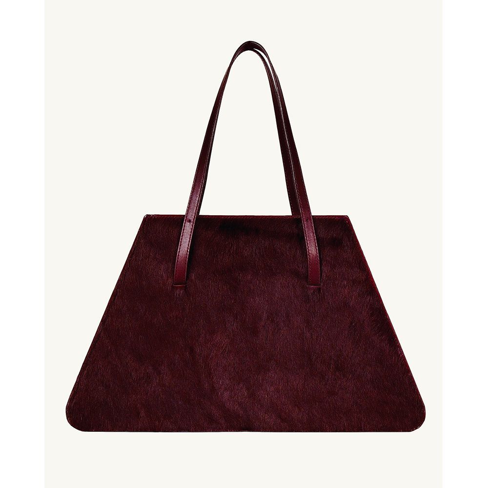 <p><strong>$775.00</strong></p><p><a href="https://www.w78st.com/shop/p/the-jolie-bag-in-burgundy-calf-hair-and-leather">Shop Now</a></p><p>Forget what you thought you knew about functional tote bags. W 78 St’s Jolie proves designs that work hard can look effortlessly cool. Inside the spacious, angular compartment—crafted from dyed calf hair and leather—you’ll find that the leather straps can adjust to three different drop lengths for your preferred way to carry.</p><p><strong>Colors: </strong>Burgundy</p><p><strong>Materials:</strong> Leather, calf hair</p>