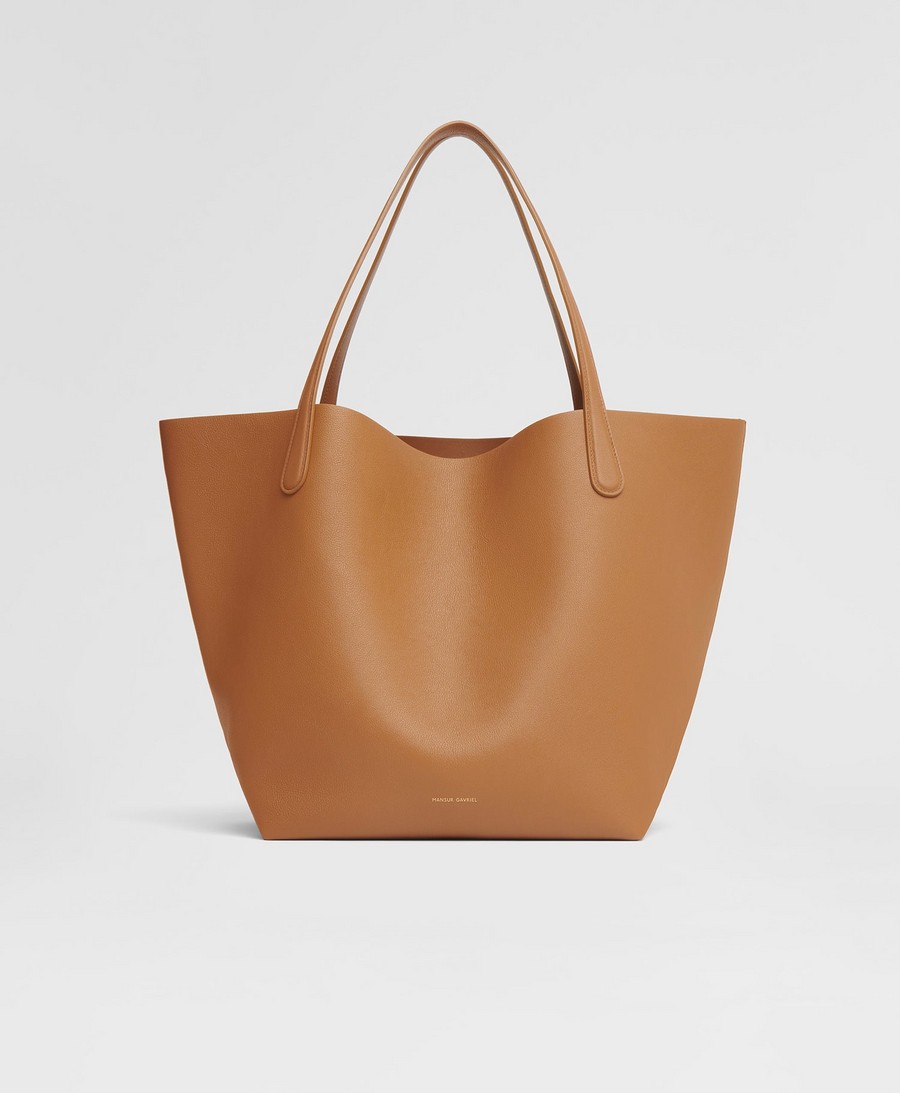 <p><strong>$515.00</strong></p><p><a href="https://go.redirectingat.com?id=74968X1553576&url=https%3A%2F%2Fwww.mansurgavriel.com%2Fproducts%2Feveryday-soft-tote-camel&sref=https%3A%2F%2Fwww.veranda.com%2Fluxury-lifestyle%2Fluxury-fashion-jewelry%2Fg46245229%2Fbest-designer-tote-bags%2F">Shop Now</a></p><p>This understated leather tote bag is a must when storage is your top priority. It’s one of the roomiest bags on my list, fitting a 16-inch laptop with plenty of space to spare. Inside, you’ll also find a coordinating leather pouch that can double as a wallet or compartment for your keys, AirPods, or other small essentials.</p><p><strong>Colors: </strong>Camel, sand, pine, black/flamma</p><p><strong>Materials: </strong>Leather</p><p><strong>What reviewers are saying: </strong>“It is large and spacious but has a great shapes that holds up well and doesn’t look massive even on a small person. Color and leather quality are lovely, very characteristic of MG bags.”</p>