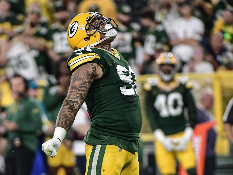 Sep 18, 2022; Green Bay, Wisconsin, USA; Green Bay Packers linebacker Preston Smith (91) reacts after a sack in the fourth quarter during game against the Chicago Bears at Lambeau Field. Mandatory Credit: Benny Sieu-USA TODAY Sports