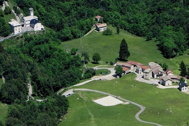 a large green landscape with houses and trees morterone village