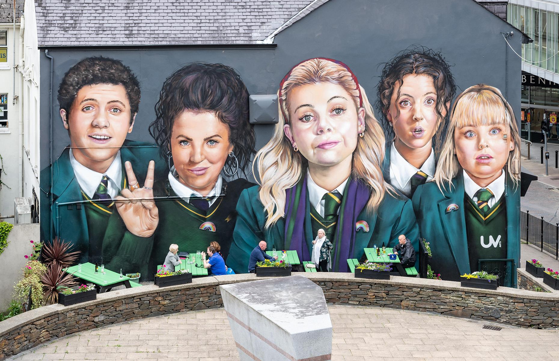 <p>In fact, there are plenty of opportunities for <em>Derry Girls </em>fans to immerse themselves in the world of these iconic characters while visiting the city. Perhaps the biggest attraction is the Derry Girls mural, painted by UV Arts in 2019 to honour the show’s impact on the city.</p>  <p>The mural is a fantastic photo opp for Derry Girls fans of all ages. </p>