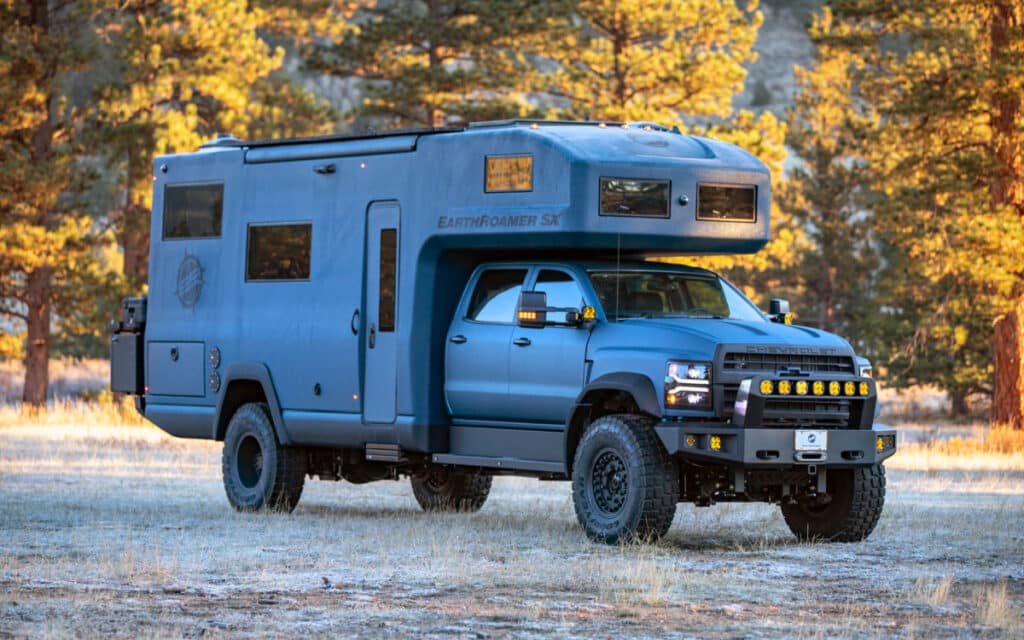 <p>This is not technically a van, we know. But we couldn’t not include the EarthRoamer SX. If you dream of the ultimate luxury experience in the wilderness, you’ve gotta take a look at it. It’s got 350 horsepower and a 6.6L turbo diesel V8! Did we mention it comes with 43″ Military Grade Goodyear Tires?</p><p>Inside, it looks like a hotel. The platform bed has wooden steps going up to it. The shower looks like it’s come out of a spa. The living room is spacious and comfortable. Can you even imagine how cushy van life would be with a washer-dryer?</p><p>While the interior is to die for, the EarthRoamer SX is also designed to provide a fantastic outdoor camping experience. It features an electric awning, LED lighting all around, and an outdoor kitchen.</p>