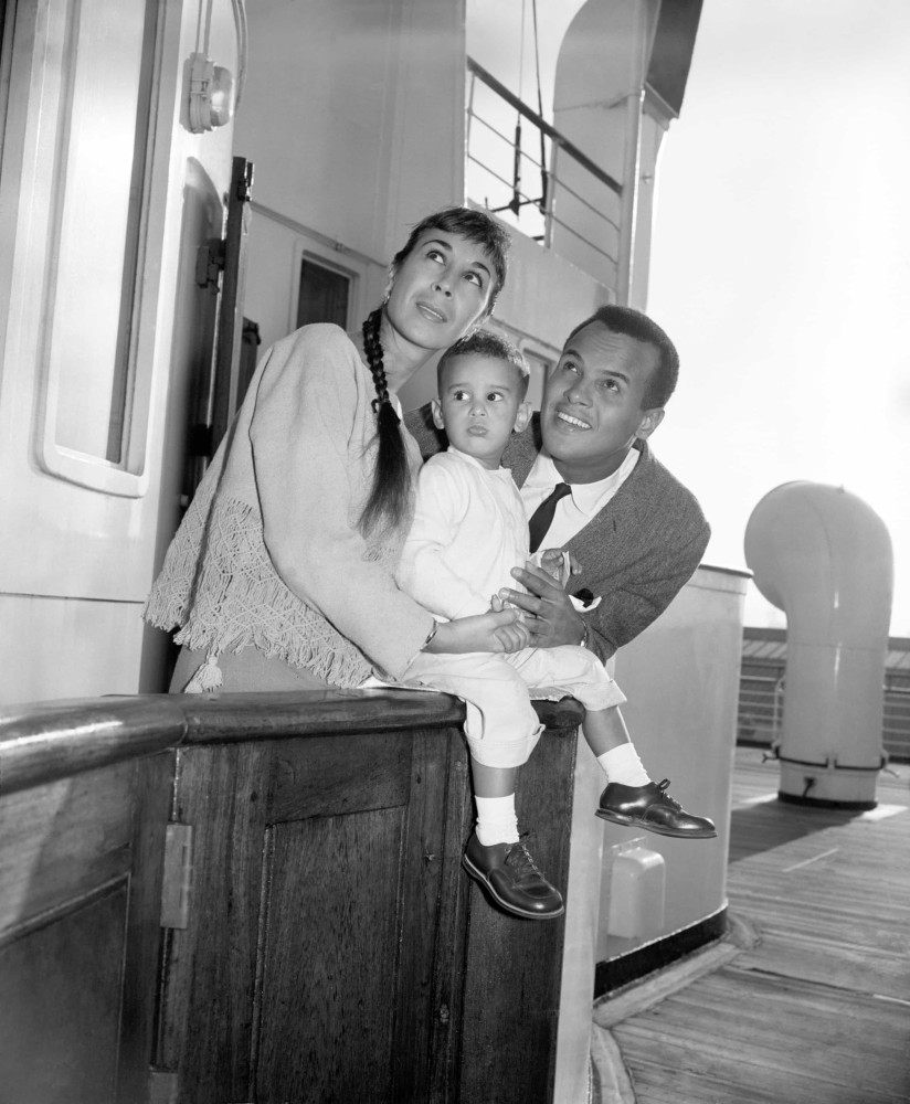 <p>Harry Belafonte, his wife Julie, and their young son David pose for the press at Southampton in 1959 after arriving from New York aboard the RMS <em>Queen Mary</em>.</p>