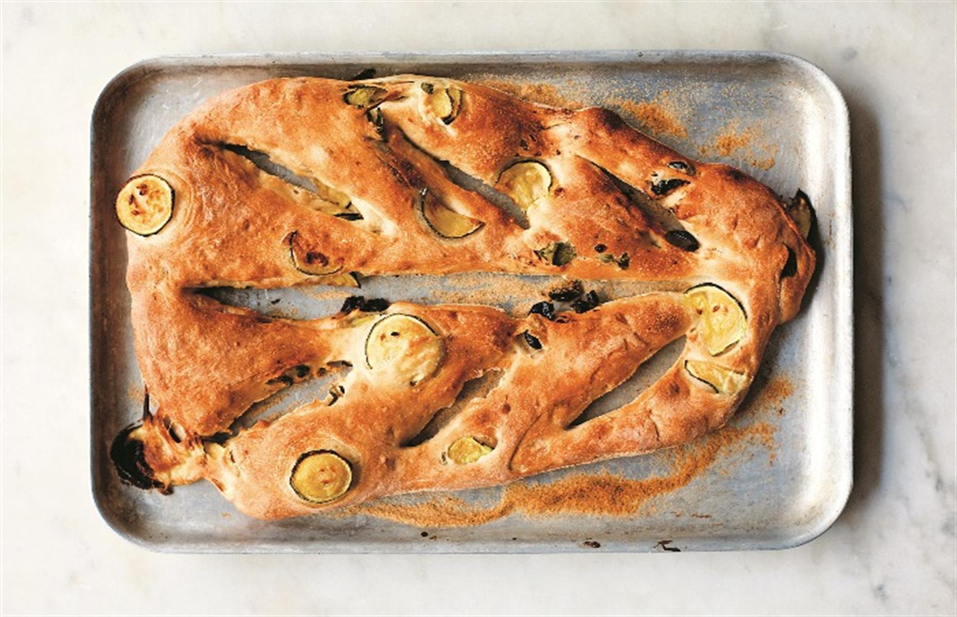 <p>Fougasse is the southern French cousin of Italy's focaccia, albeit with a chewier crust. It's traditionally shaped like a blade of wheat and baked in a very hot oven – if you have a baking or pizza stone, use it here to achieve the signature crunchy crust. Spraying the oven with water just as you put the bread in also helps to get the bread that bit crispier.</p>  <p><a href="https://www.lovefood.com/recipes/87324/fougasse-with-courgettes-and-olives-recipe"><strong>Get the recipe for fougasse with olives and courgettes here</strong></a></p>