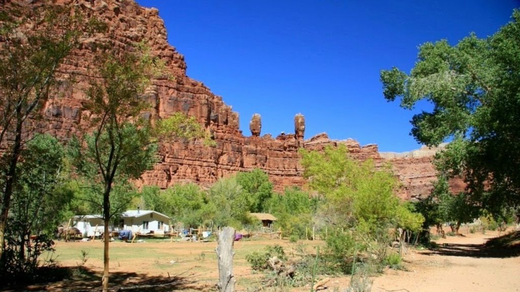 <p>If you want to visit Supai, Arizona you will need to be comfortable riding horses, hiking eight miles, or hitching a ride on a helicopter. It is such a remote village that it is the only place in the United States that the mail is delivered by a mule!</p><p>It is predominantly occupied by an ancient tribe called the Havasupai; they have lived in this canyon for centuries. What it lacks in convenience it makes up for in character, featuring beautiful turquoise waterfalls, red rock canyons, and the pools of Havasu Creek.</p>