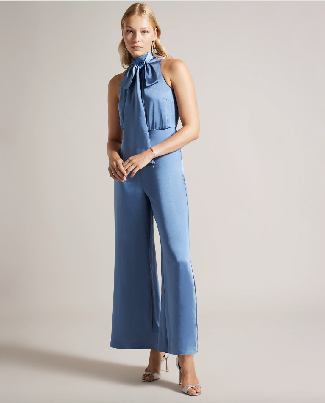 <p><strong>£112.00</strong></p><p><a href="https://www.tedbaker.com/uk/p/Womens/Clothing/Jumpsuits-and-Playsuits/AMBRIAA-Satin-Pussybow-Jumpsuit-Blue/271813-BLUE">Shop Now</a></p><p>We think Ted Baker's blue satin jumpsuit is beyond perfect for upcoming spring/summer weddings. If you're a guest opt for tousled waves and metallic accessories, or bridesmaids can rock sleek low buns. </p>