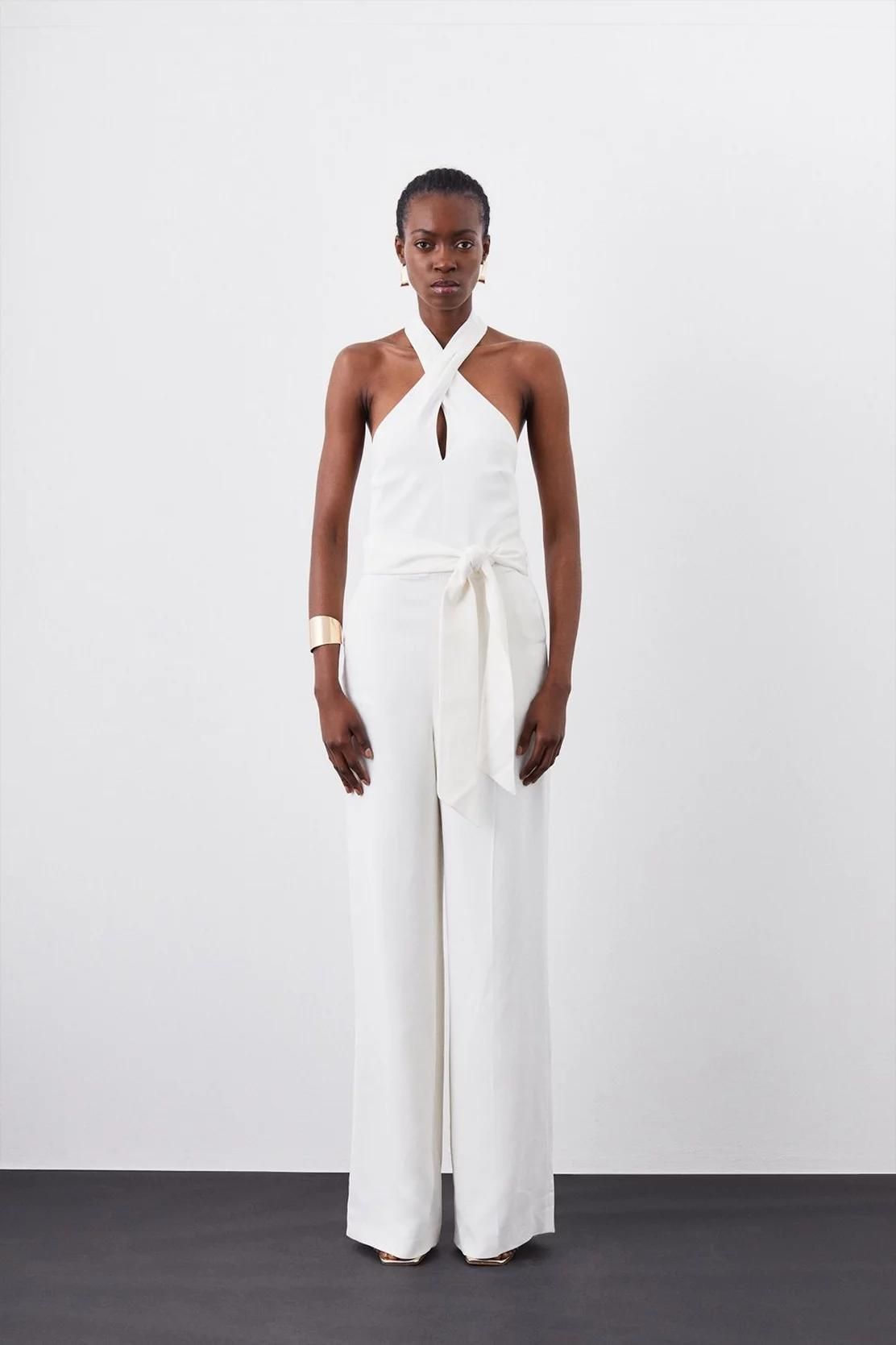 <p><strong>£96.00</strong></p><p><a href="https://www.karenmillen.com/petite-compact-viscose-stretch-drape-tailored-jumpsuit/BKK11584.html">Shop Now</a></p><p>For shorter gals, finding a jumpsuit that won't trail on the floor and get ruined is a real chore. Which is why we love Karen Millen's petite range. This lil' number feels v '70s thanks to the halter neckline and flared trousers. </p>