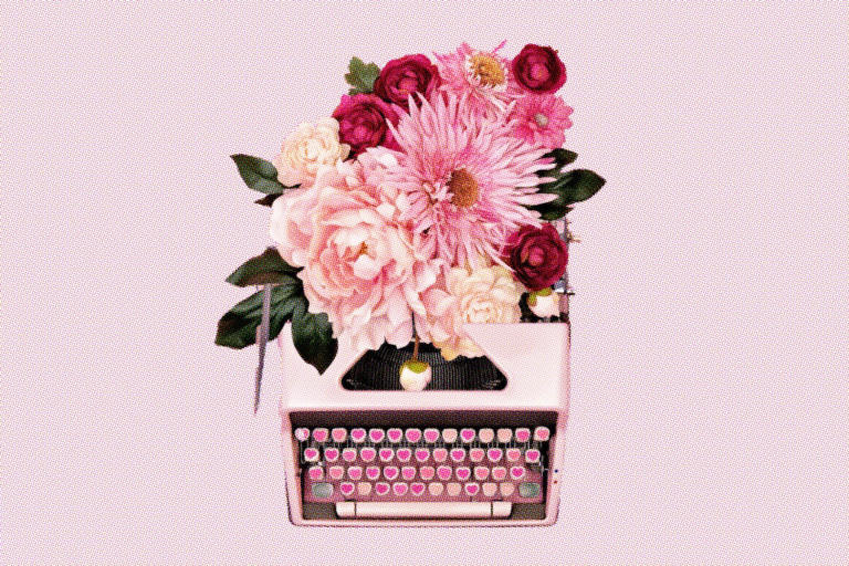 pink typewriter with bouquet of flowers coming from the top