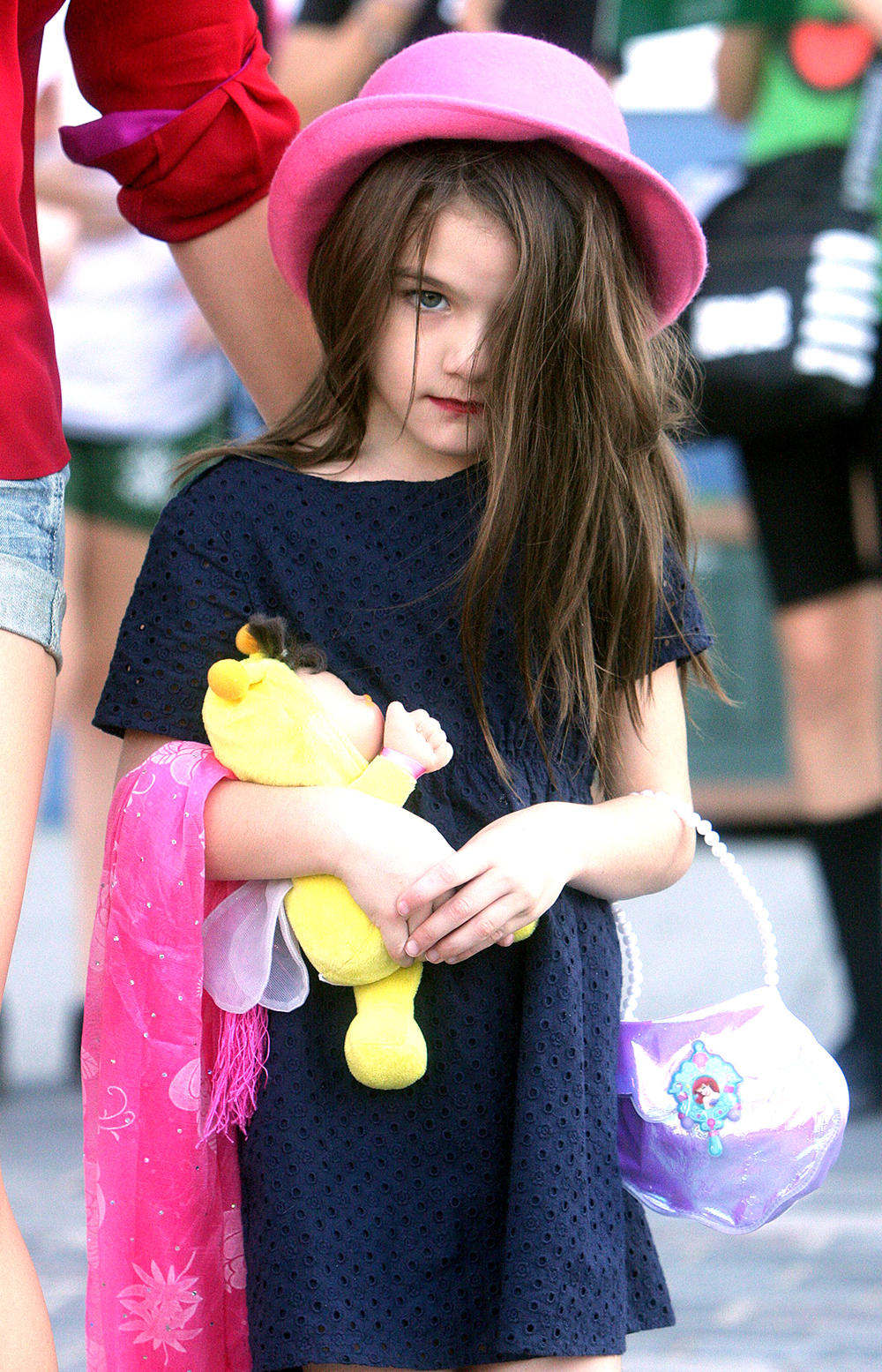 <p>Katie Holmes and Suri Cruise out and about in New York on September 9, 2011. Suri wore a cute pink hate and carried a baby doll on her stroll. </p>