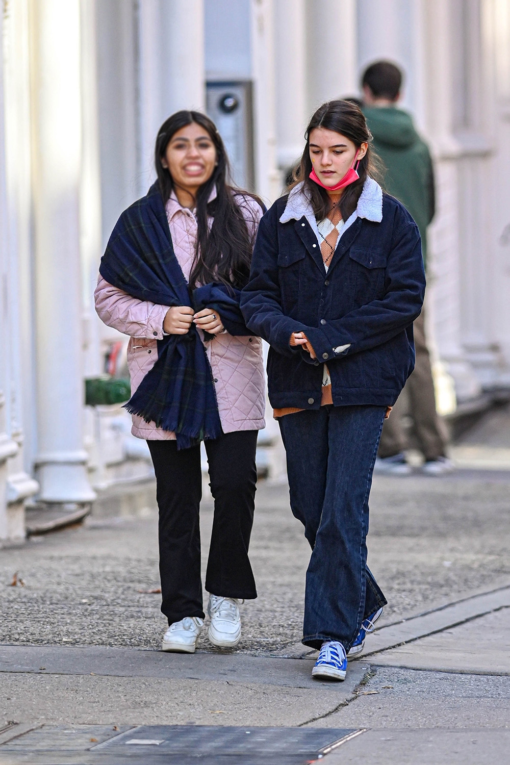 <p>Suri Cruise looked all grown up when she went for a stroll with a friend in New York City, while wearing a pair of dark wash flared jeans with a tan argyle sweater and an oversized navy blue corduroy jacket on top. She also wore blue sneakers.</p>
