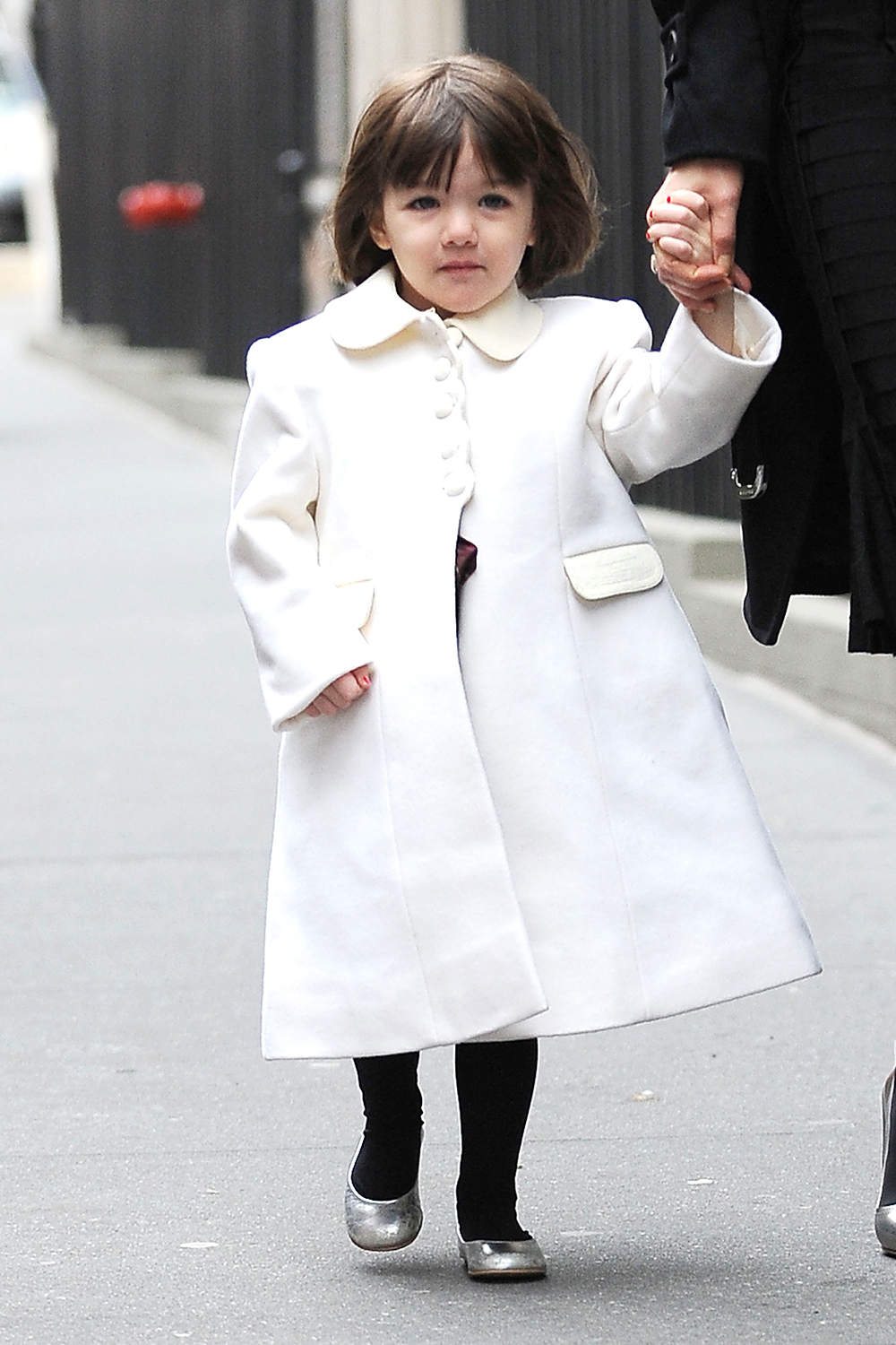 <p>Suri Cruise goes to a birthday party in December 2008. She was bundled up in a white coat. </p>