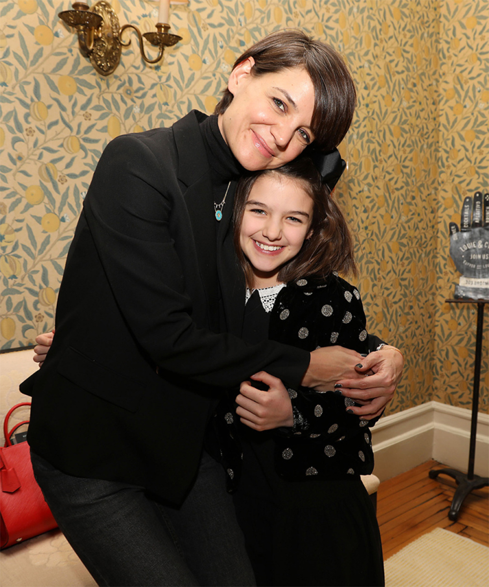 <p>Suri Cruise and her mom, Katie Holmes, cuddled up for a picture! Suri looked just like her mom’s mini-me!</p>