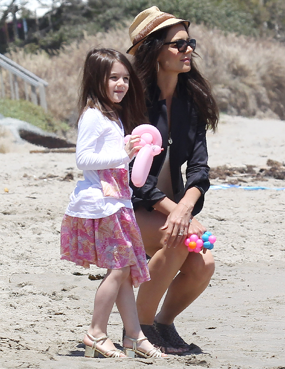 <p>Katie Holmes and Suri Cruise enjoyed Memorial Day at the beach in Malibu on May 30, 2011. The pair were dressed up for some fun festivities. </p>