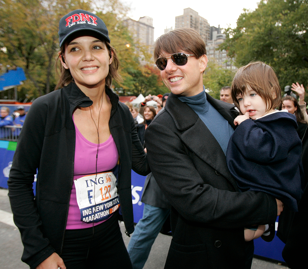 <p>Actress Katie Holmes joins her husband Tom Cruise as he holds their daughter Suri after Holmes finished the New York City Marathon in New York. The couple smiled for pictures. </p>