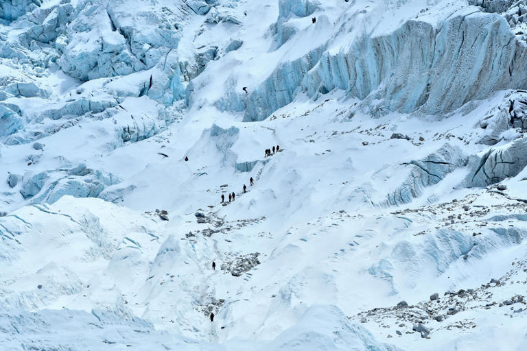 In this photograph taken on May 1, 2021 mountaineers trek along the Khumbu glacier near Everest base camp in the Mount Everest region of Solukhumbu district, some 140 km northeast of Nepal's capital Kathmandu.
