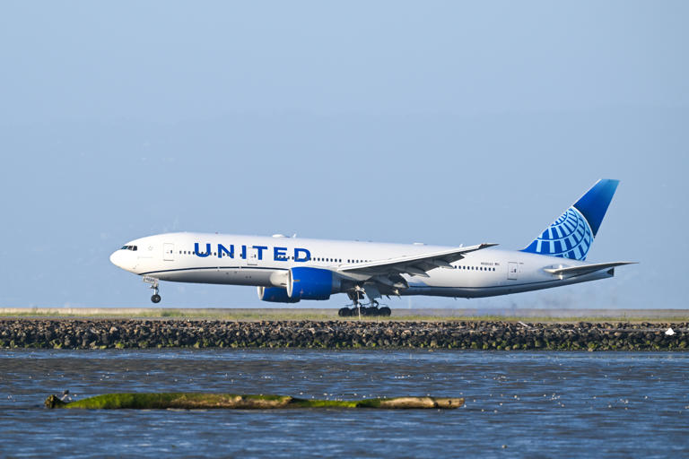 A United Airlines plane lands at San Francisco International Airport (SFO) in San Francisco, California, United States on April 22, 2024. Airlines will now be required to give automatic refunds for delayed or canceled flights under a new DOT rule.