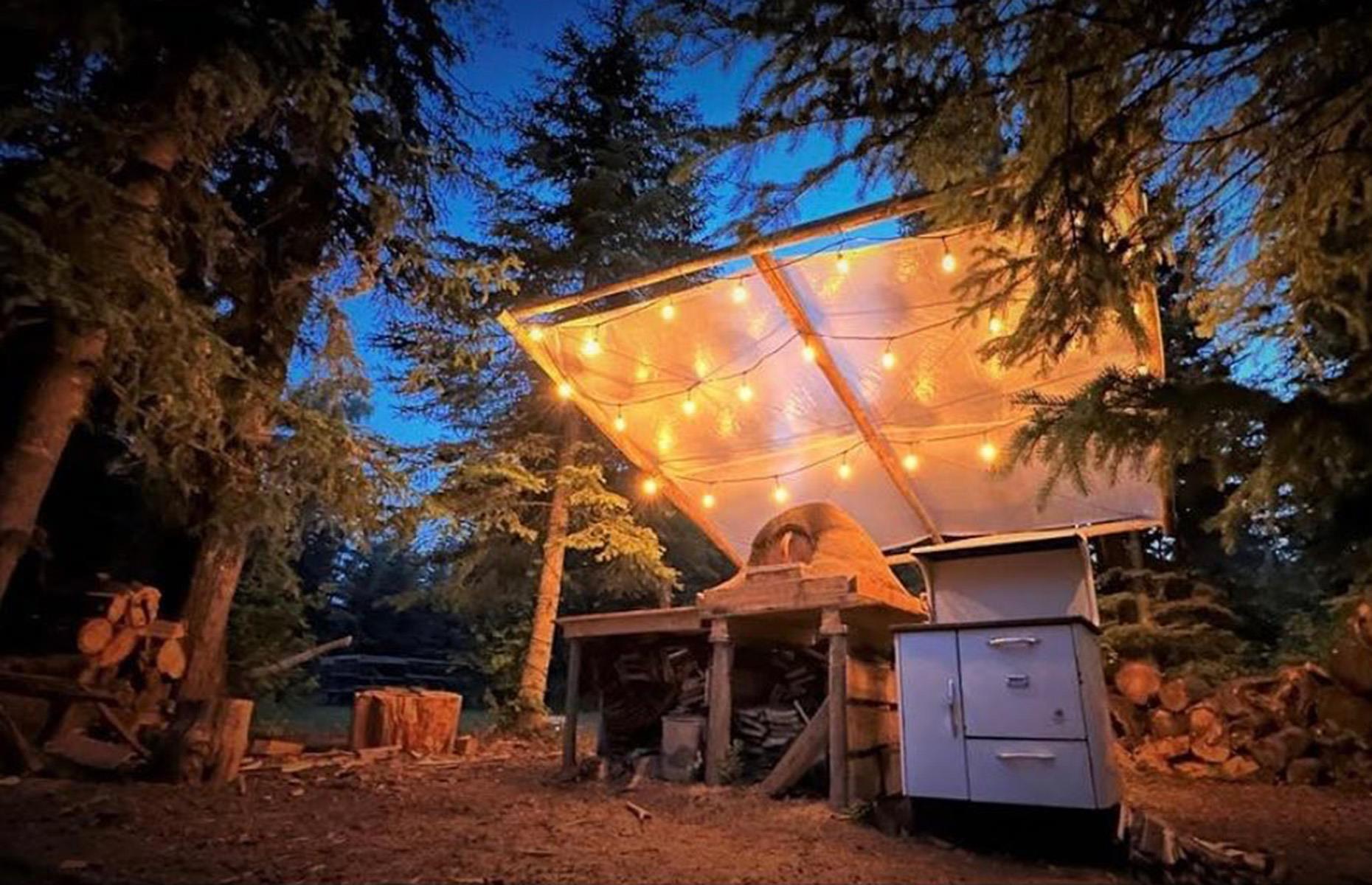 <p>Keen to make the most of the great outdoors, in the summer of 2023, the family built their own beautiful outdoor kitchen. Complete with a suspended retractable roof, LED fairy lights and an old family pizza oven, the alfresco cooking station is the perfect place for summer gatherings beneath the tree canopy.</p>