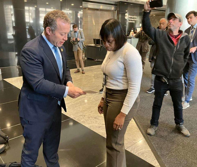U.S. Rep. Josh Gottheimer, D-5th Dist., hands a note to a MTA employee for CEO Janno Lieber in the lobby of MTA headquarters in New York City on Wednesday. Gottheimer wants to see the math used to calculate the $15 congestion pricing fee, contending that it raises three times more revenue than needed.