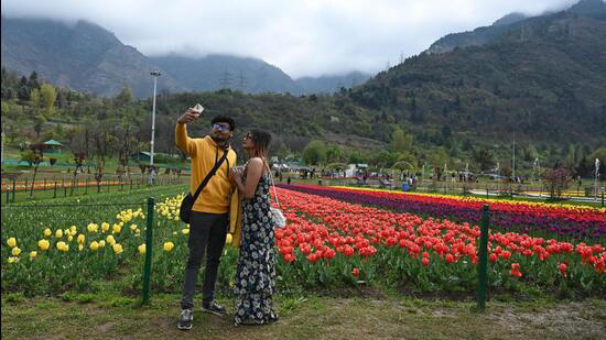 Tourists at the Tulip garden in the foothills of Zabarwan moutains in Srinagar, Kashmir.
