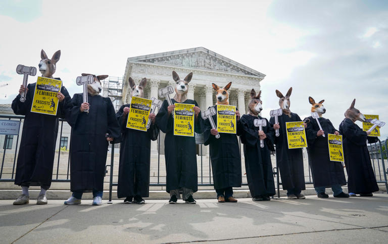 Protestors gather outside of the US Supreme Court on April 25, 2024 as the Supreme Court justices hear oral arguments on whether former President Donald Trump is immune from criminal charges in his federal election interference case in Washington, DC.