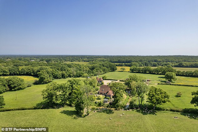 an englishman's home really is his castle! stunning grade ii-listed manor in rural kent that's surrounded by a moat is on sale for £4.5million