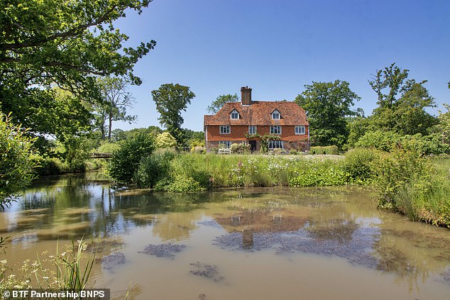 an englishman's home really is his castle! stunning grade ii-listed manor in rural kent that's surrounded by a moat is on sale for £4.5million