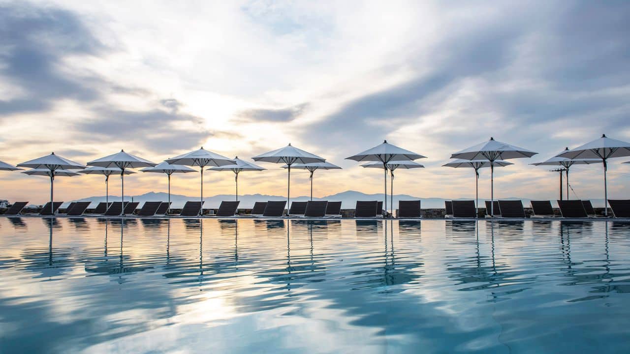 <p>The resort’s pools make for a unique and modern contrast against an island of such history, though its freeform shapes mimic the waves of the Aegean Sea.</p>