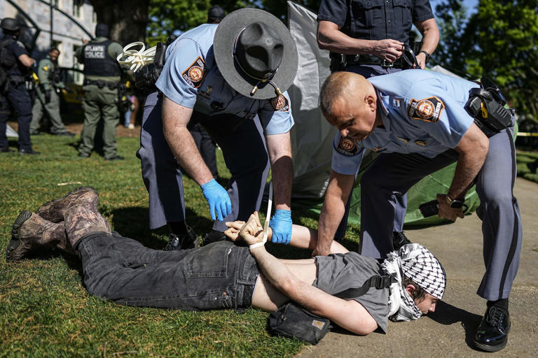A protester is detained by police during a pro-Palestinian demonstration on the campus of Emory in Atlanta on April 25. (Mike Stewart/AP)