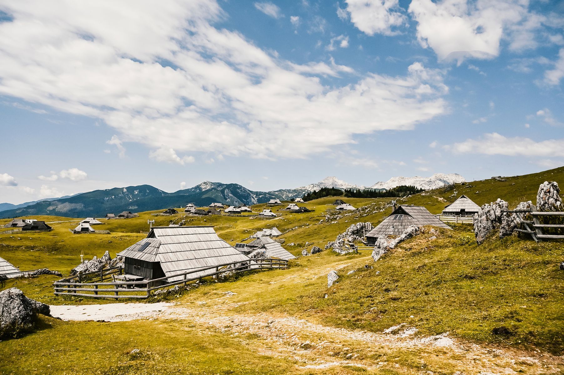 <p>Located in the <a href="https://www.slovenia.info/en/places-to-go/kamnik-savinja-alps">Kamnic Alps</a>, <a href="https://www.slovenia.info/en/places-to-go/attractions/velika-planina">Velika Planina</a> is Europe’s largest herdsmen’s village, and offers a glimpse into authentic Slovenian shepherd life. In summer, you can take a cable car up to the plateau. Once at the top, you’ll find lush green pastures dotted with traditional wood cottages, plus astonishing views of the surrounding peaks. It’s the ideal place for taking a peaceful hike through alpine meadows or sampling local specialties such as mountain cheese.</p>