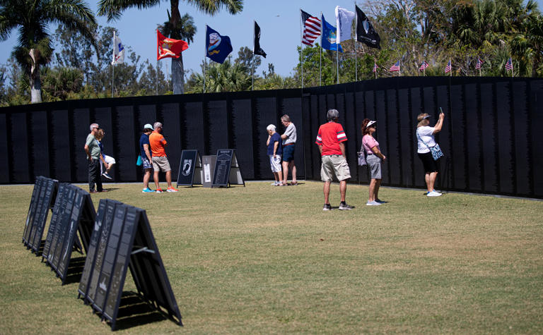 Visitors take in the Vietnam Traveling Wall and Cost of Freedom display at Lakes Regional Park in Fort Myers on Thursday, April 25, 2024. The display is open to the public through Sunday evening at dusk.