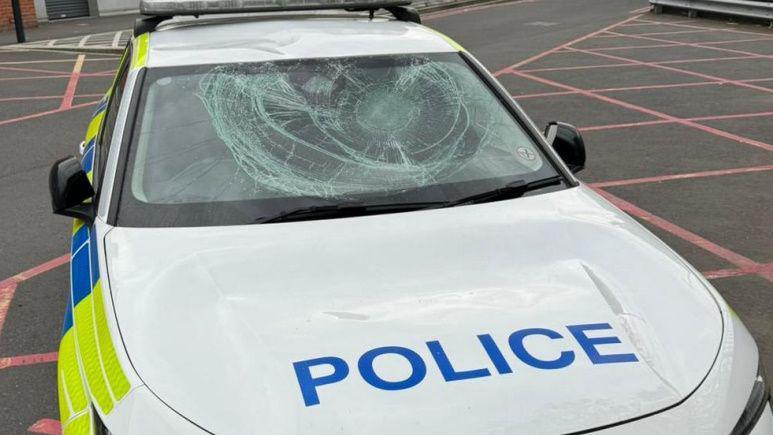 police car damaged after man jumps on windscreen