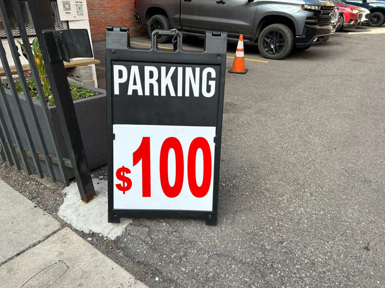 A parking lot at Griswold and Grand River in downtown Detroit advertises spots for $100 during Day 1 of the NFL draft.