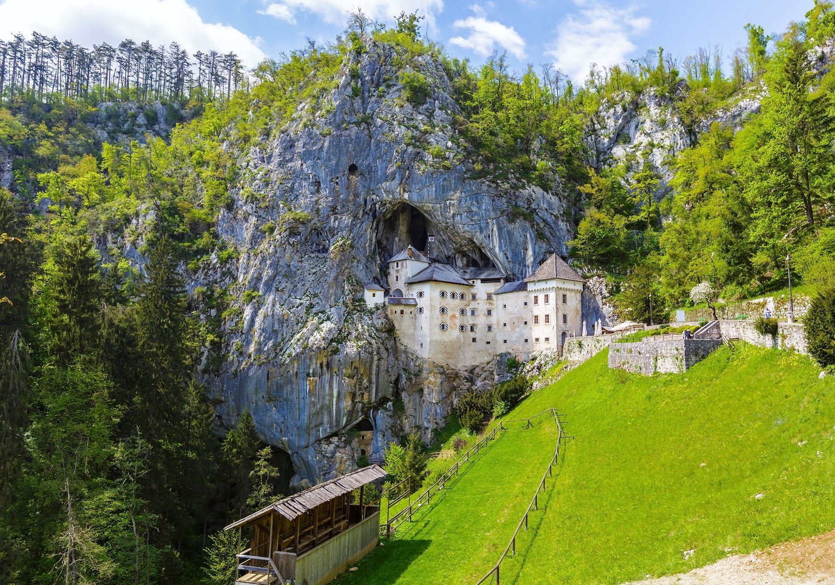 <p>Located near Postojna Cave, this 13th-century <a href="https://www.postojnska-jama.eu/en/predjama-castle/">medieval castle</a> was built right into the side of a limestone cliff. You may have already seen Predjama Castle in the TV series <em>The Witcher</em>, but this is your chance to plunge into another era and wander through the impregnable fortress’s dungeons, rooms and secret passages. The castle is said to have belonged to Erasmus Lueger, a knight-turned-brigand who stole from nobility and gave back to the poor, much like the fabled Robin Hood.</p>