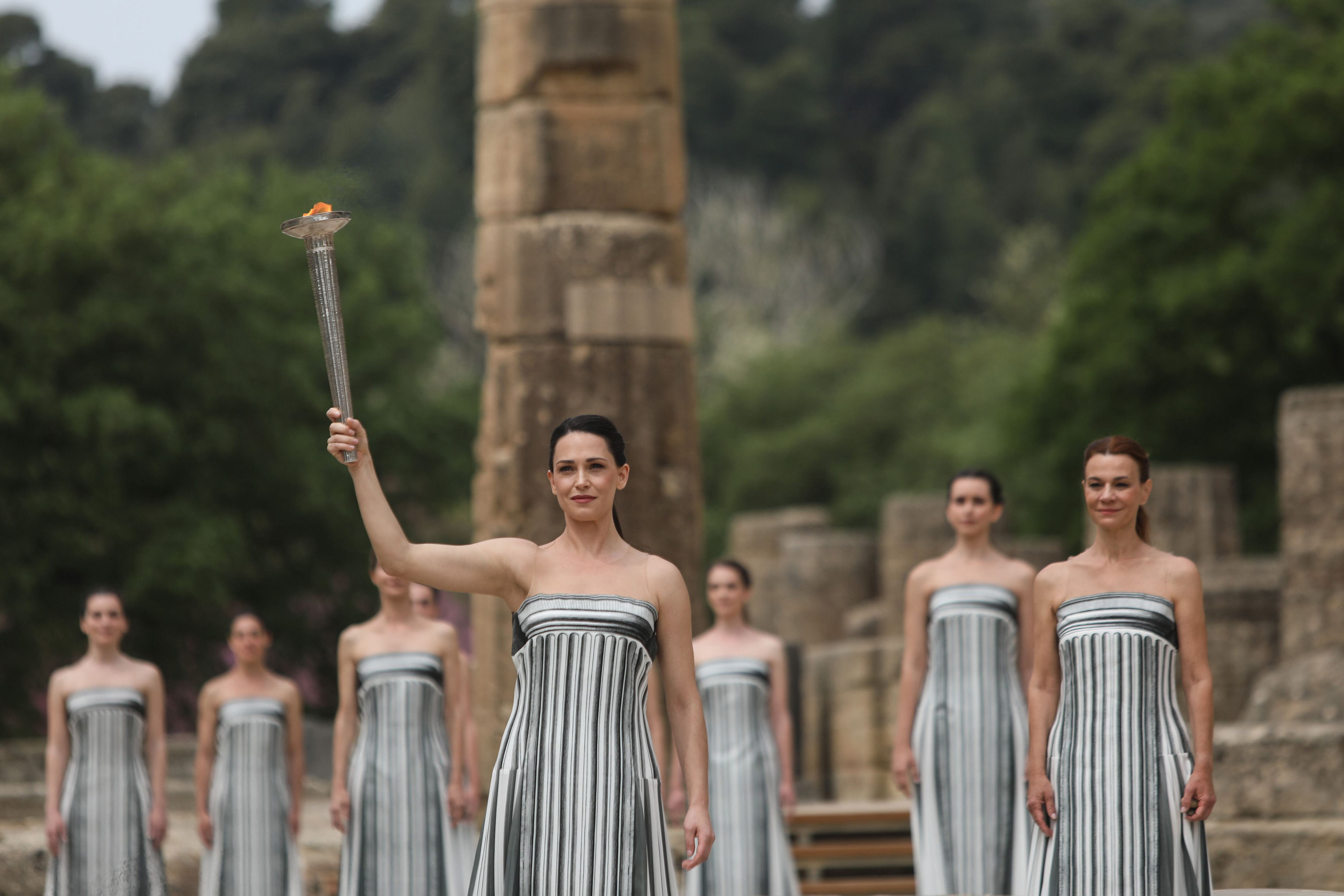 olympic flame handed to paris as it prepares to leave greece on historic sailing ship
