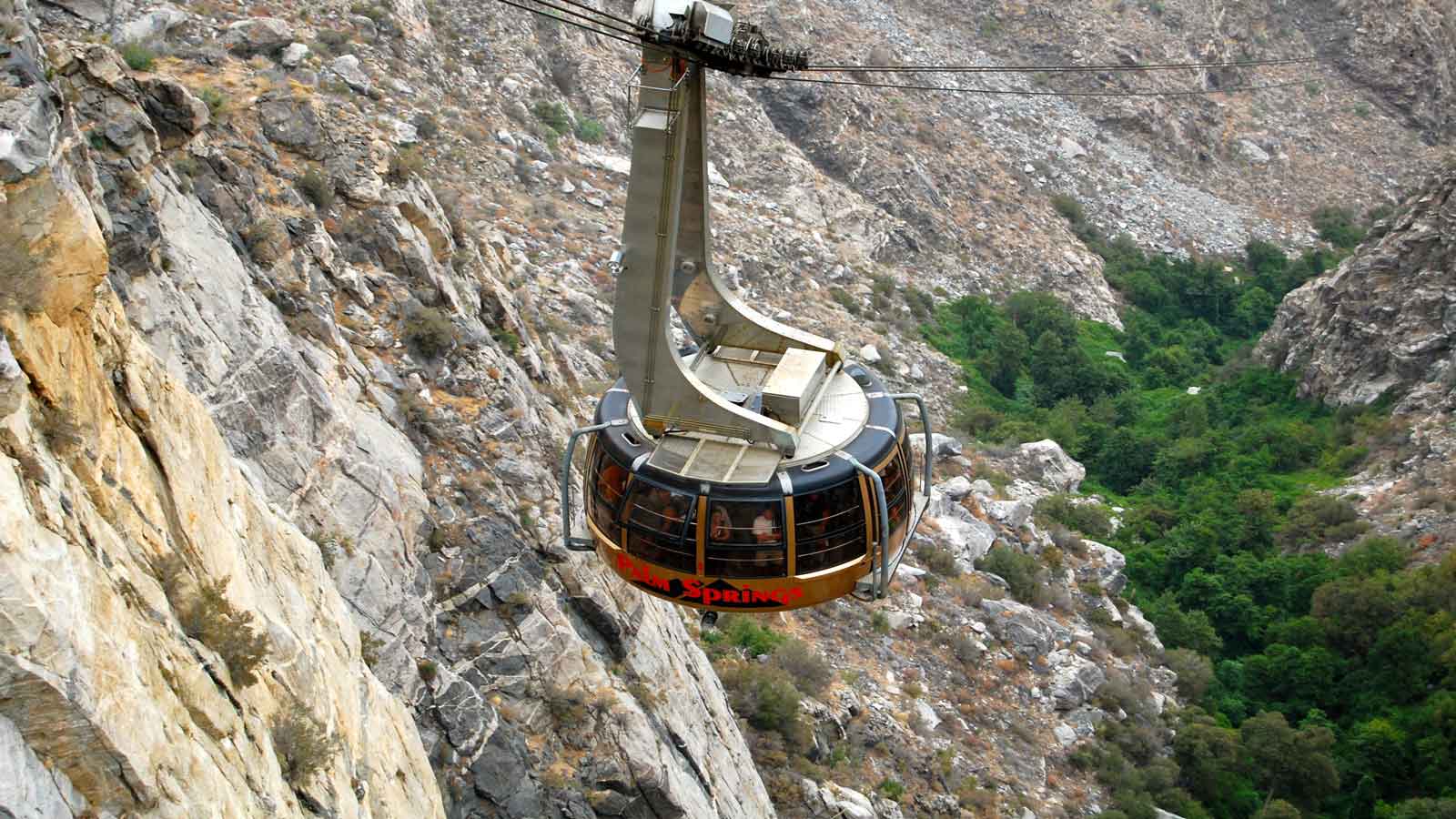 <p><span>The world’s largest rotating tram car, the Palm Springs <a href="https://pstramway.com/" rel="nofollow noopener">Aerial Tramway</a> travels over two and one-half miles along the awe-inspiring cliffs of Chino Canyon, delivering riders to the pristine grounds of the Mt. San Jacinto State Park. The trams rotate slowly during this approximate 10-minute ride, offering guests picturesque views to capture those perfect memories. </span></p><p><span>Once you reach the Mountain Station, you are greeted with two restaurants, a natural history museum, observation decks, gift shops, and over 50 miles of hiking trails to test your endurance. Tickets can be bought online beforehand.  </span></p>