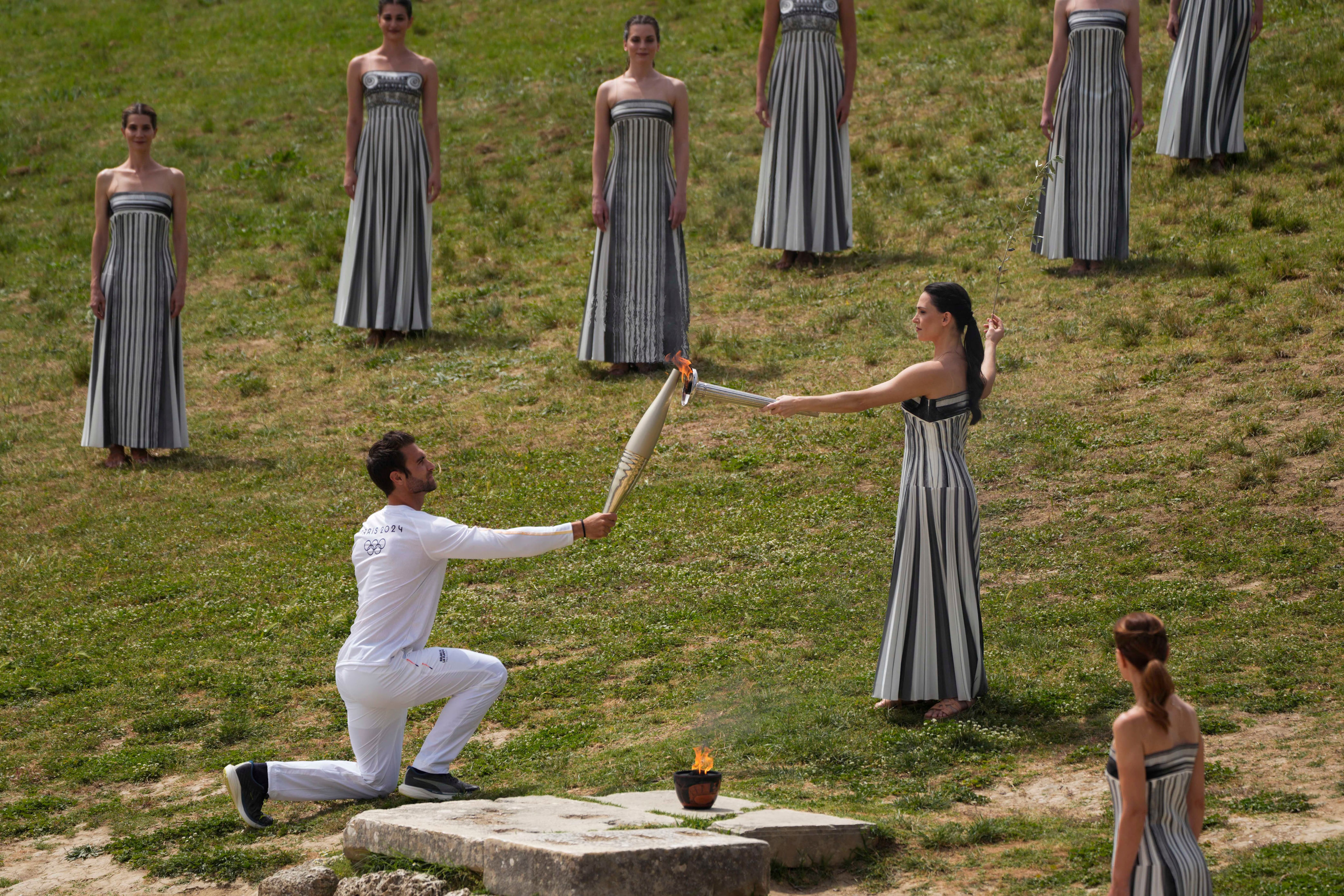 olympic flame handed to paris as it prepares to leave greece on historic sailing ship