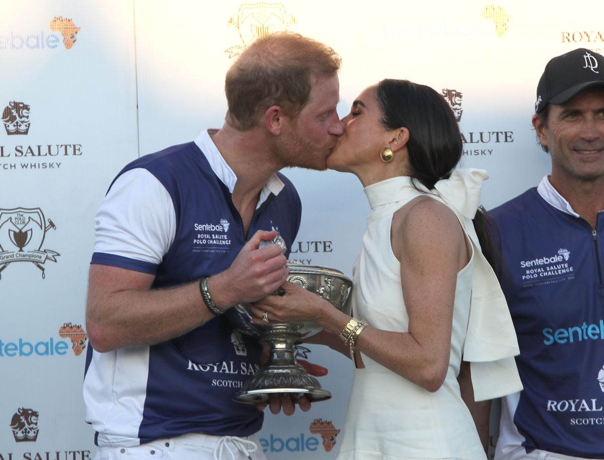 <p>Harry and Meghan shared a kiss after she presented him with the trophy. <a href="https://www.townandcountrymag.com/society/tradition/a60471407/meghan-markle-harry-polo-match-palm-beach-fashion-2024/">More details on Meghan's outfit, here.</a></p>